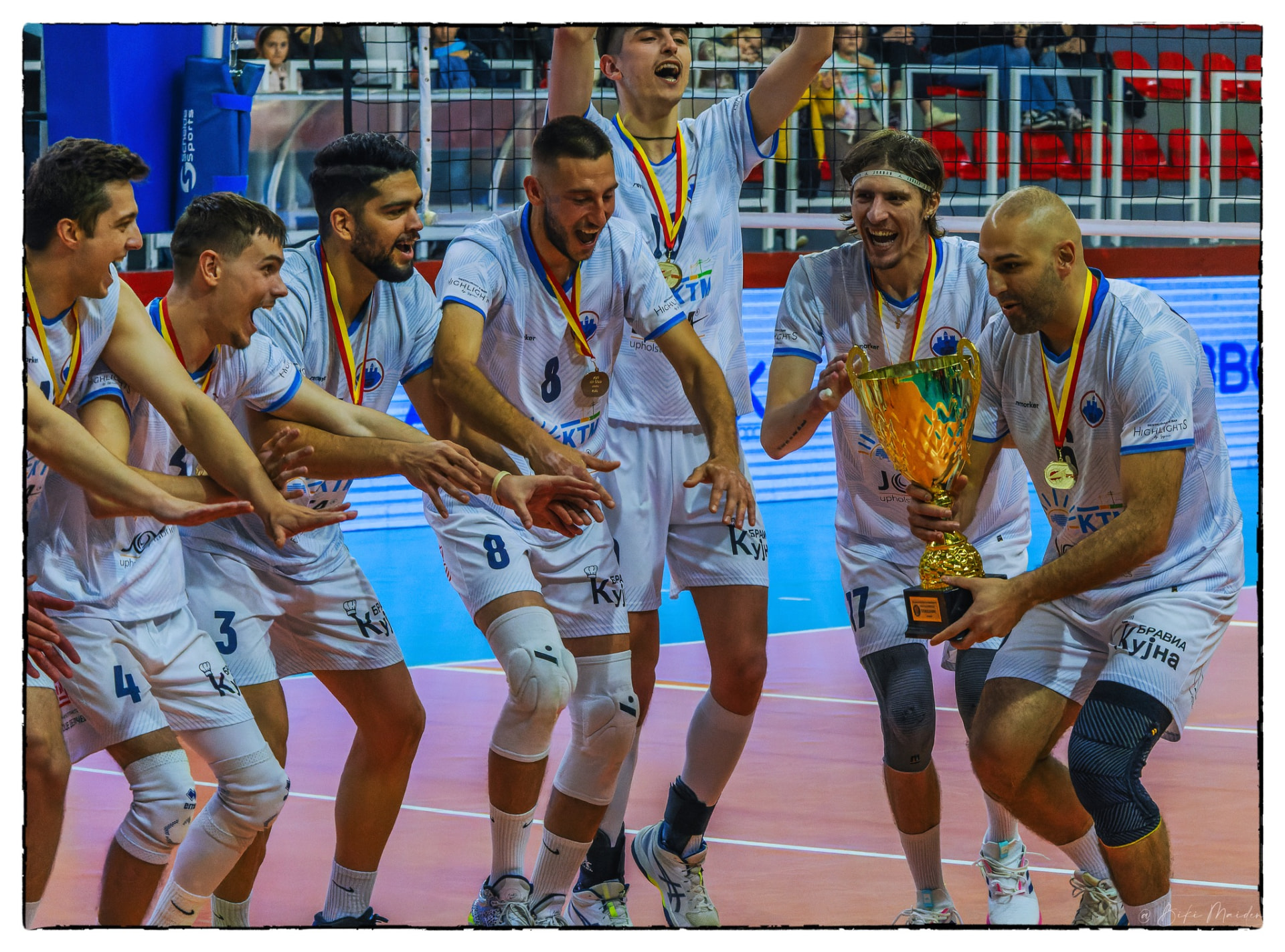 Players celebrating with the cup trophy
